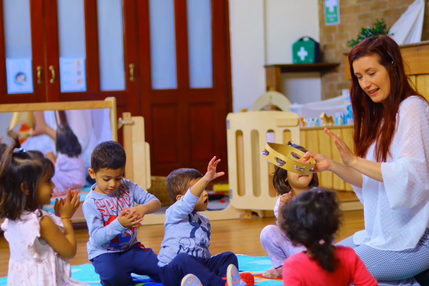 Children enjoying circle time with music at Maygardens Little Learners nursery Northolt