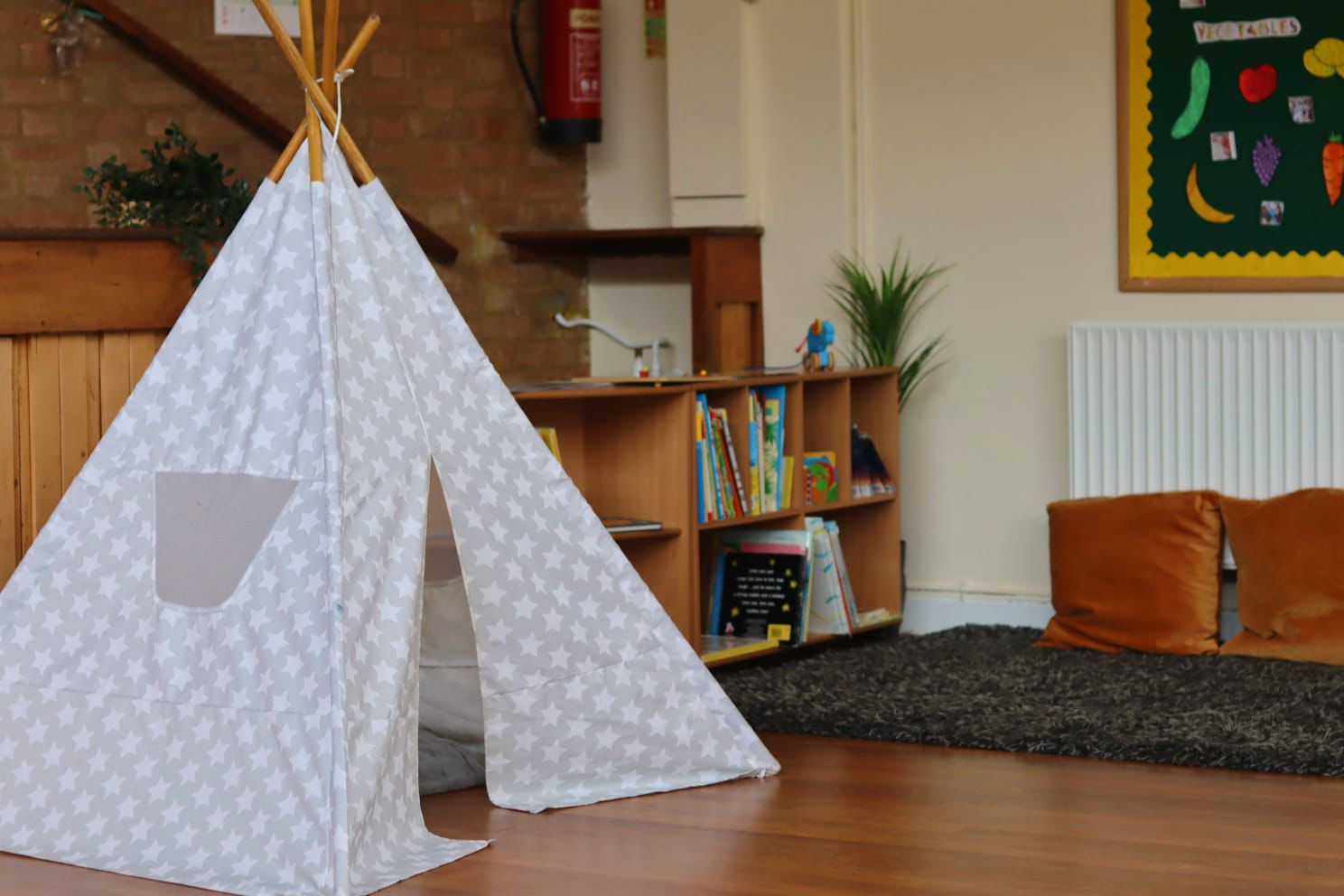 Warm and inviting nursery room with teepee and reading corner at Maygardens Little Learners